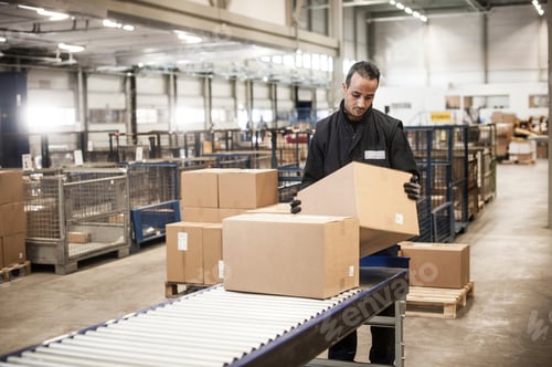 Preview: Male Warehouse Worker Checking Cardboard Box From Conveyor Belt