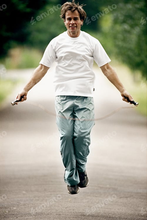 Adult Man Jumping Rope on a Quiet Road