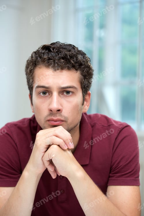 Preview: Young Man Resting Chin On Clasped Hands
