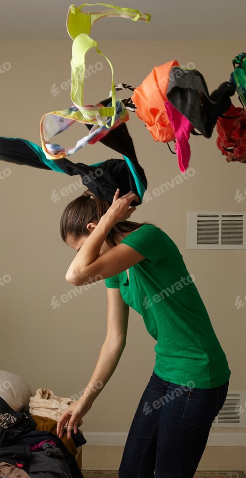 Preview: Mid Adult Woman Anxiously Looking For Garment