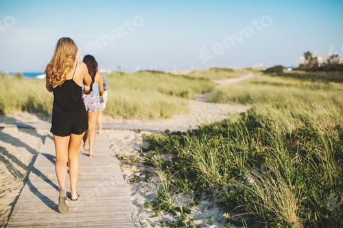 Preview: Rear View Of Women At Beach Walking On Coastal Path