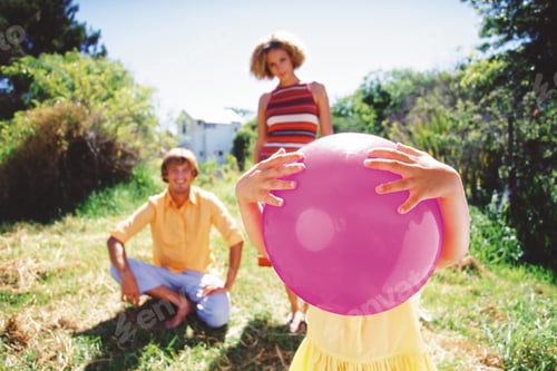 Preview: Girl Holding Ball With Parents