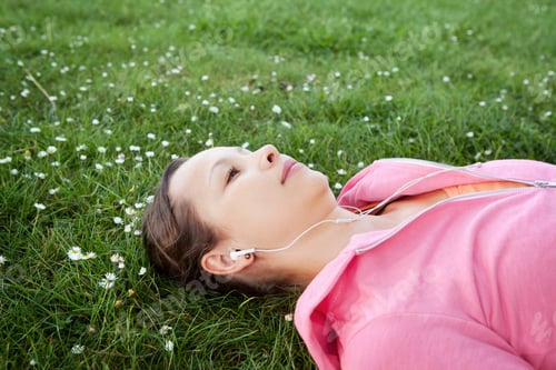 Preview: Woman Relaxing on Grass Listening to Music