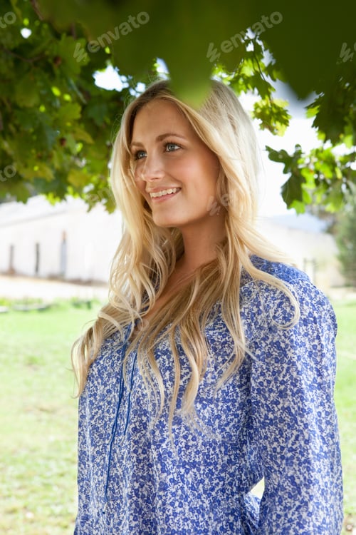 Preview: Smiling Woman Standing Under Tree
