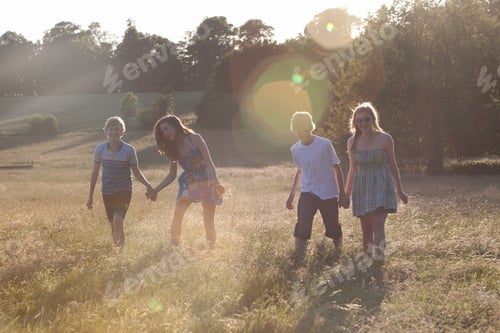 Preview: Teenage Couples Walking In Field