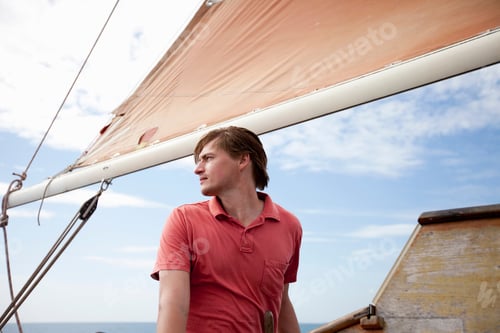 Preview: Man Standing Under A Sail