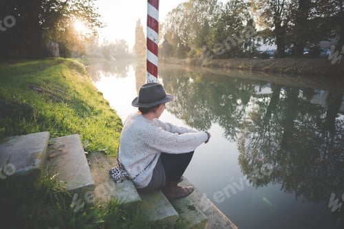 Preview: Young Woman Sitting On Steps By River, Dolo, Venice, Italy