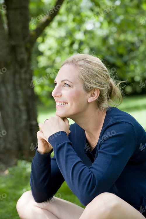 Preview: Smiling Woman Sitting Outdoors
