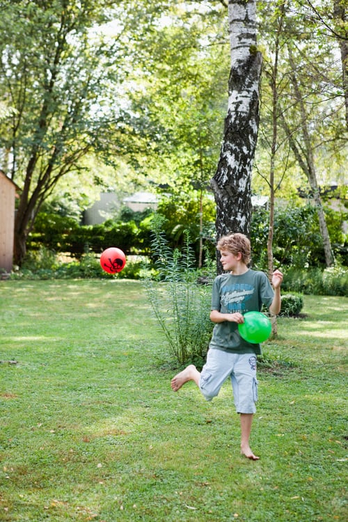 Preview: Boy Playing With Two Balls In Garden