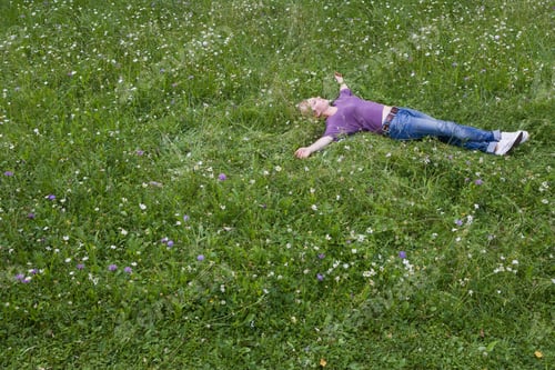 Preview: Smiling Woman Laying In Grass