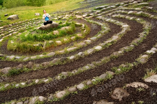 Preview: Woman Meditating In Stone Labyrinth