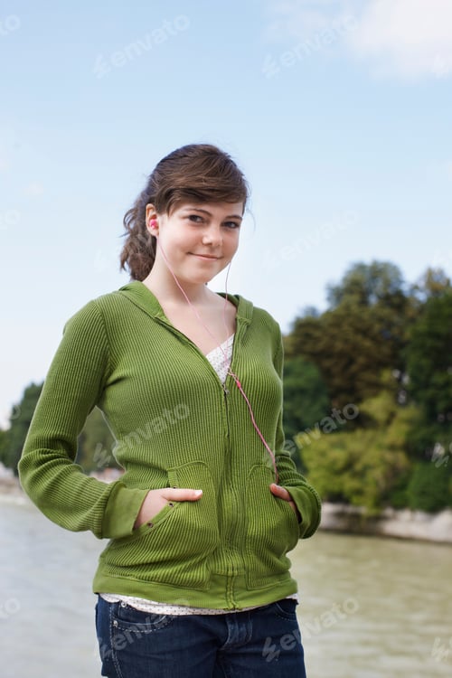 Preview: Young Girl Listening To Ipod Near River