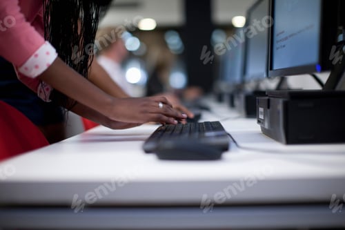 Preview: Female Student Using Computer Keyboard In Class