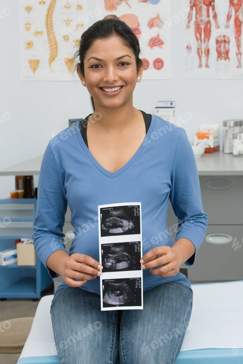 Preview: A Pregnant Woman Holding A Scan