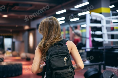 Preview: Rear View Of Young Woman Carrying Backpack Preparing For Gym