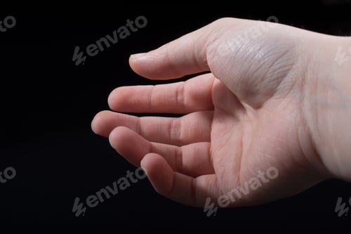 Preview: Five Fingers Of A Child Hand Partly Seen In Black Background