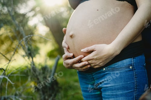 Preview: Belly Of Pregnant Woman Walking By In Nature