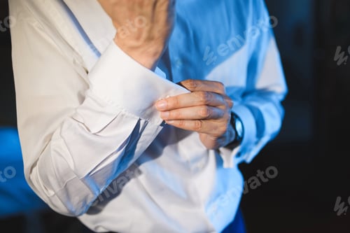 Preview: Man Buttons Cuff on Crisp White Shirt