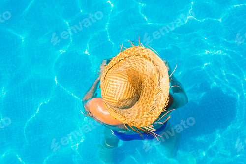 Preview: Woman In A Pool With Hat Relaxed And Rested.