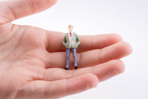 Preview: Hand Holding A Human Figure On A White Background