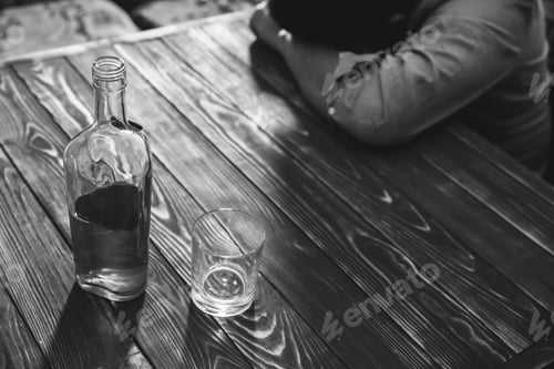 Preview: Alcoholic Addict. Man Near The Table With Alcohol And A Glass. Dangerous Habit. Unhealthy Life