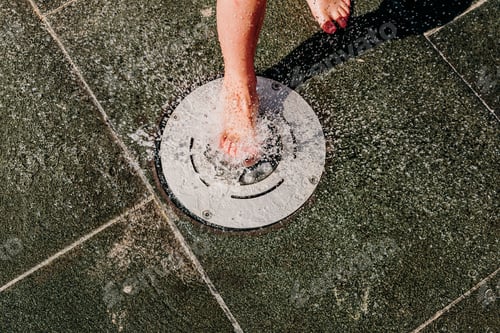 Preview: Young Barefoot Boy Running Through Squirting Water In A Pool In A Spa.
