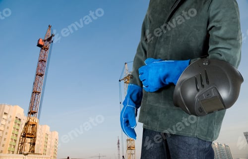Preview: Male Welder Closeup With Welding Equipment On Building Background