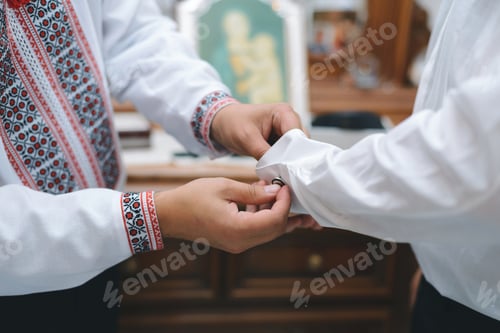 Preview: Groomsman Helping Groom To Button Sleeve Link On Shirt