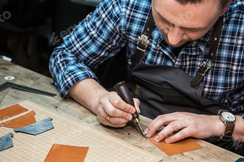 Preview: Man Working With Leather Textile At A Workshop. Concept Of Handmade Craft Production Of Leather