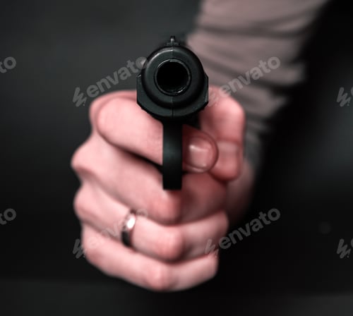 Preview: Male Hand With Gun Isolated On Black Background. Man With A Gun Ready To Shoot, Focus On The Weapon.