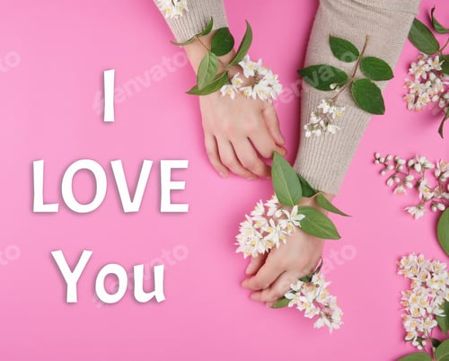 Preview: Two Female Hands, White Flowers And The Inscription I Love You On A Pink Background, Top View
