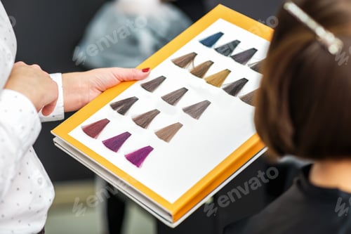 Preview: Stylist'S Hand Holding Palette Of Hair Dye Samples In Beauty Salon, Close Up.