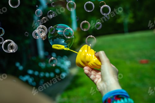Preview: Little Girl Playing Soap Bubbles In The Backyard In The Sun