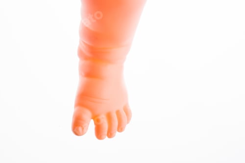 Preview: Baby Doll'S Legs On A White Background