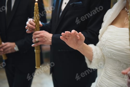 Preview: Bride Holding Two Golden Rings On Finger At Church Ceremony
