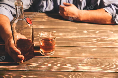 Preview: Alcoholic Addict. Man Holding With Alcohol And A Glass. Dangerous Habit. Unhealthy Life Concept