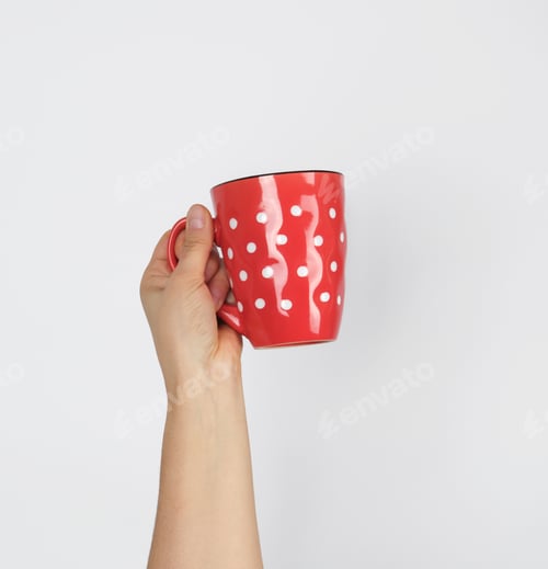 Preview: Red Ceramic Cup In A Female Hand On A White Background, Hand Is Raised Up