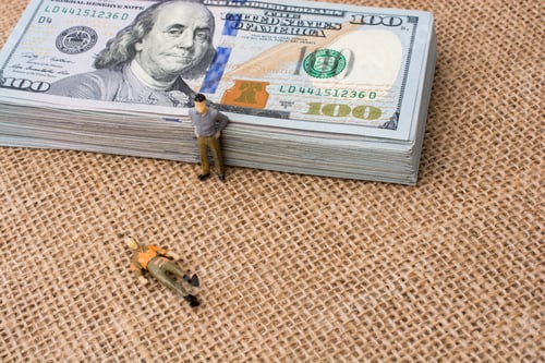 Preview: Men Figurines Found Beside The Bundle Of Us Dollar Banknote