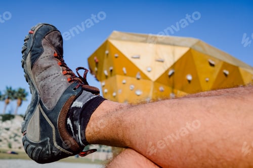 Preview: Boots Of An Adventurer Resting Before Training On A Climbing Wall.