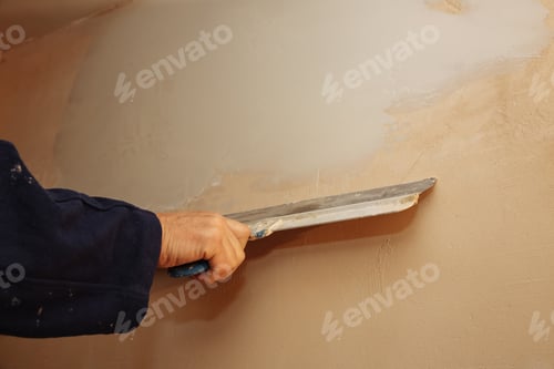 Preview: Man Is Priming A Surface With A Palett Knife. Maintenance Repair Works Renovation In The Flat