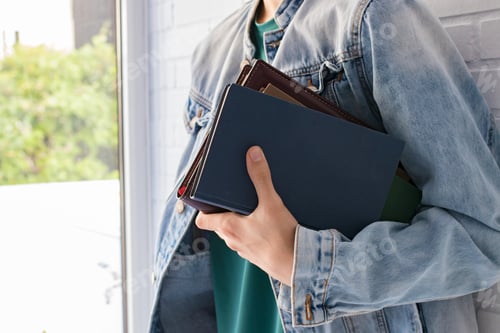 Preview: Student Hand With College Or University Books