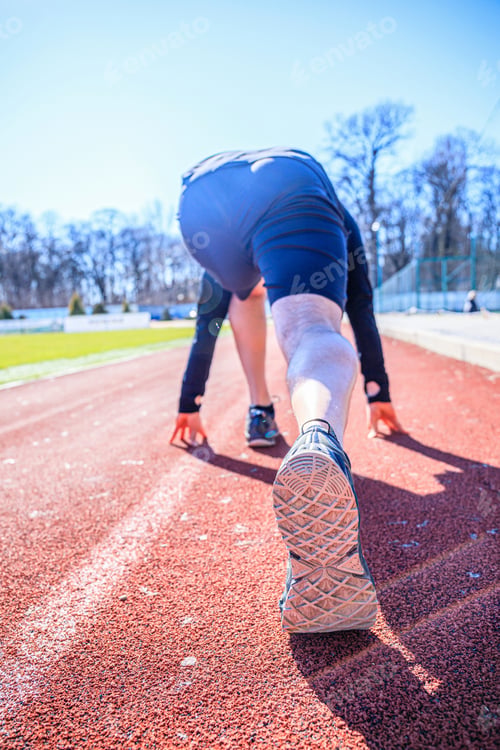 Preview: Feet On Starting Block Ready For A Spring Start. Focus On Leg Of A Athlete About To Start A Race In
