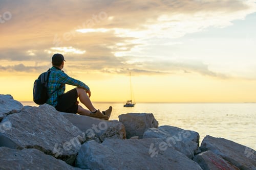 Preview: Man With Backpack Looking On Sunset Over The Sea. Copy Space