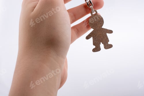 Preview: Man Shaped Keyholder In Hand On White Background