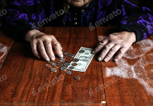 Preview: Old Woman With Very Little Money. Poverty Concept. Pensioner With One Dollar Note And Coins In