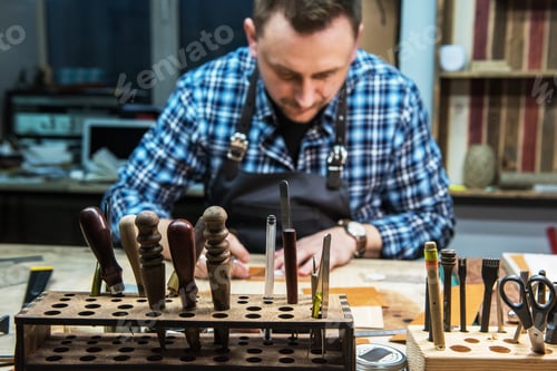 Preview: Man Working With Leather Textile At A Workshop. Concept Of Handmade Craft Production Of Leather