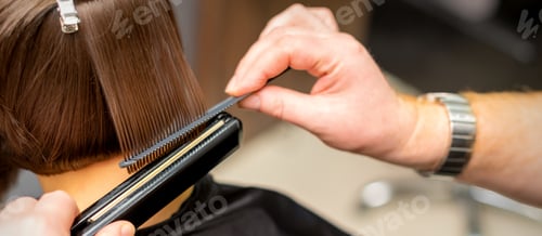 Preview: Close Up Of The Hairdresser Straightening The Short Hair Of A Female Client With A Hair