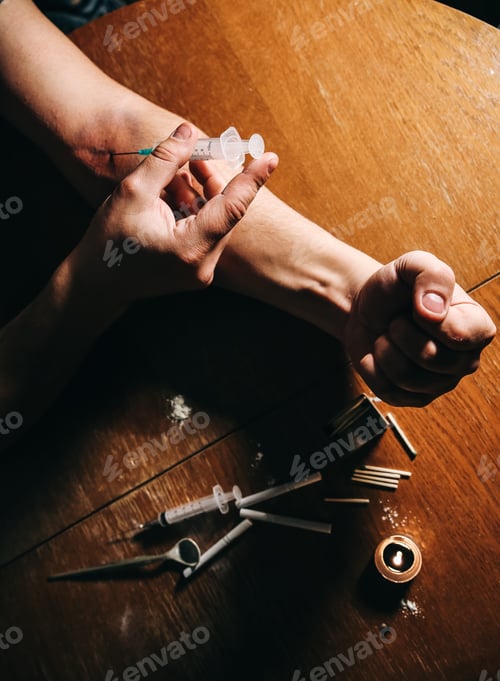 Preview: Man Shooting Heroin With Needle Syringe. Drugs Addict. Candle Burning With Matches And Cigarettes