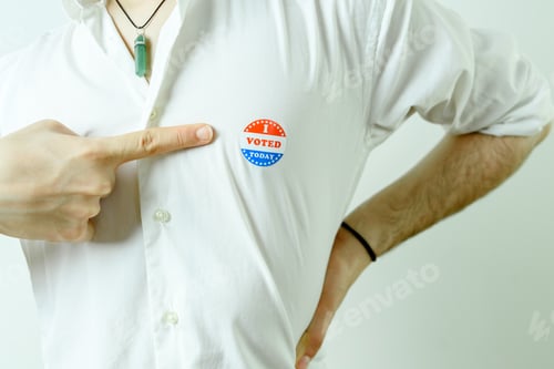 Preview: Man Pointing To An I Voted Today Sticker On His Chest.