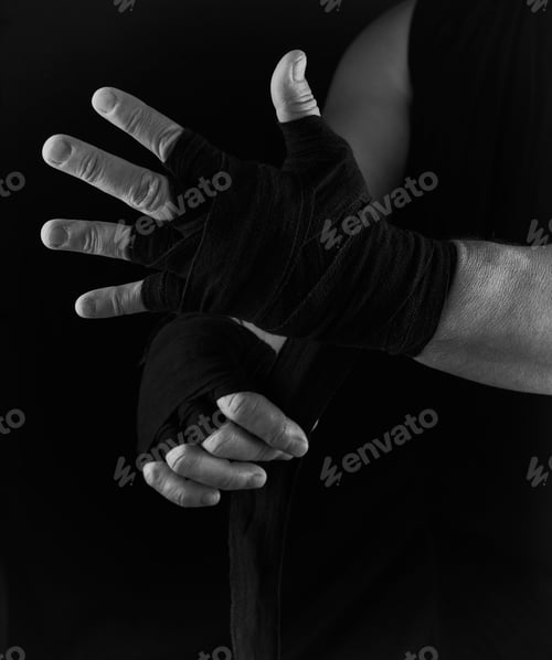 Preview: Man Wraps His Hands In Black Textile Bandage For Sports, Black White Toning